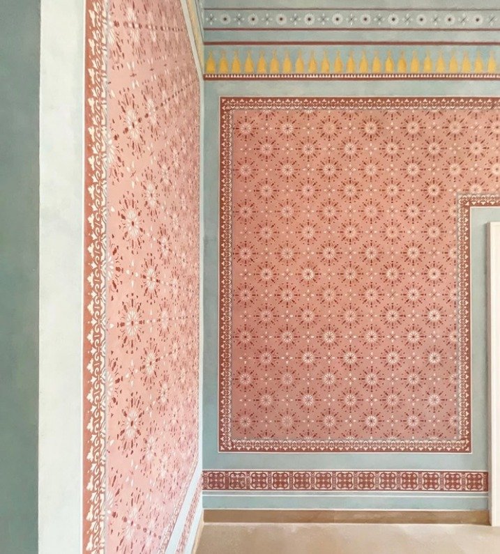 Hand-painted rose terracotta and sage arabesque wall pattern – Al Ghanem Residence