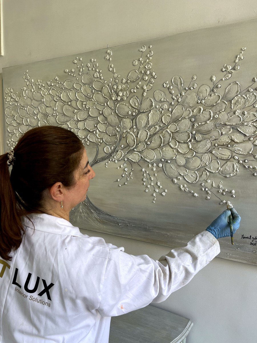 Artisan creating a sculpted relief finish on a wall