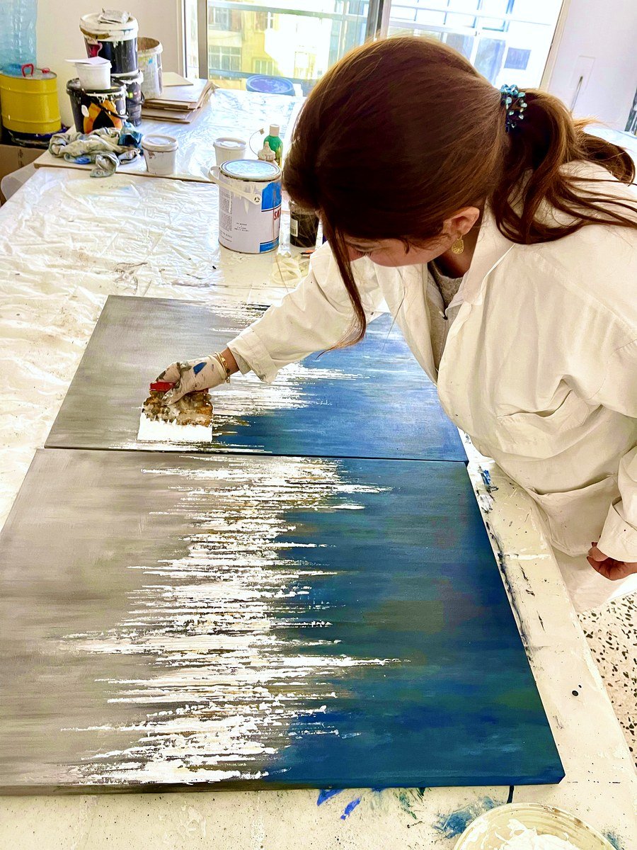Artisan working on an abstract gold and blue panel